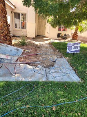 Demolishing sidewalk.