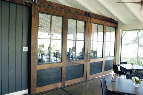 Custom wood, blackened steel and chicken wire glass barn doors at Mumm Napa Winery