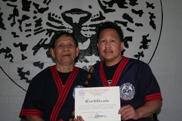 Senior Grandmaster Cacoy Canete presenting Sensei Gary Wong with his 3rd Dan in Cacoy Doce Pares