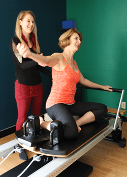 Susan B. Stack, working with Pilates client for functional movement and strength