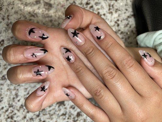 almond shaped nails with star design and rainbow Stones/gem