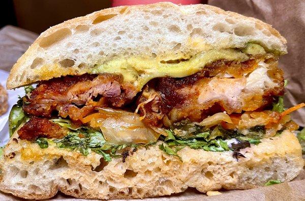 Korean chicken sandwich - gochujang bbq sauce, crispy chicken, avocado, kimchi, lettuce, sriracha aioli on ciabatta