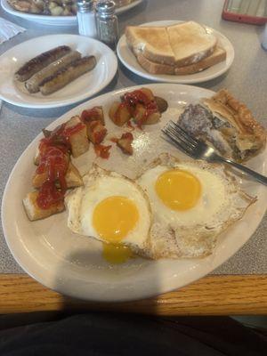 Pork pie with 2eggs and pan fries with a side of sausage