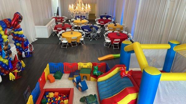 Enough room for gift table, cake display with balloons, seating for 100 and soft play area