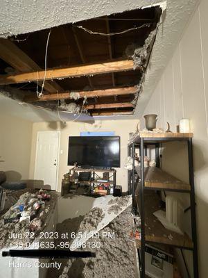 Living room with roof collapsed. Totally not a big deal though, right????