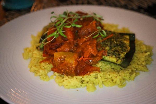 Steamed Hake on a banana leaf with turmeric rice, cilantro chutney and stewed tomatoes / gluten free