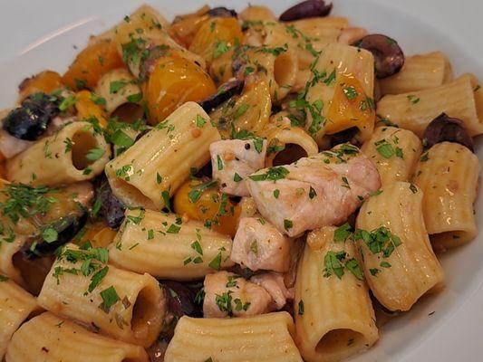 Mezzemanich pasta with swordfish and imported yellow tomatoes, and kalamata olives