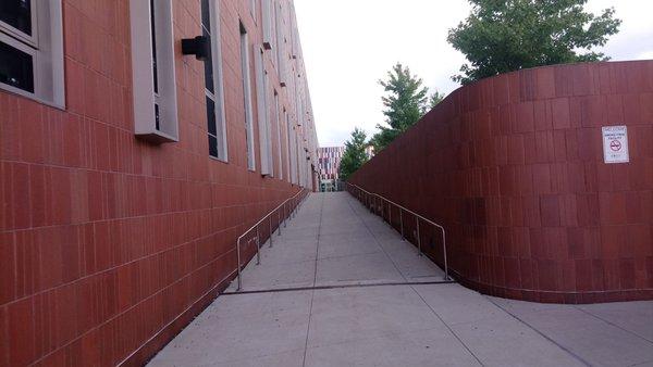 Walkway/ramp on east side of school that leads to additional school entrance, Chicago Public Library entrance and park - like area.