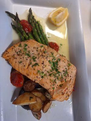 Blistered green beans and grape tomatoes with roasted red potatoes baked salmon with a lemon butter and parsley.