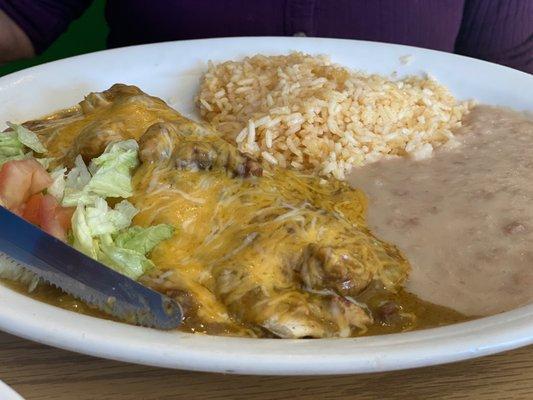 Smothered green chili burrito, rice and beans.