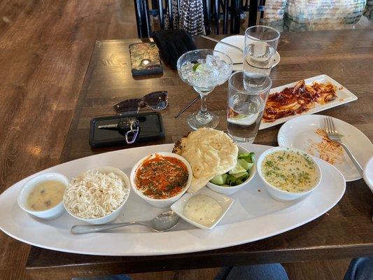 From right to left, potato soup, salad, butter chicken and nann, rice, rice pudding.