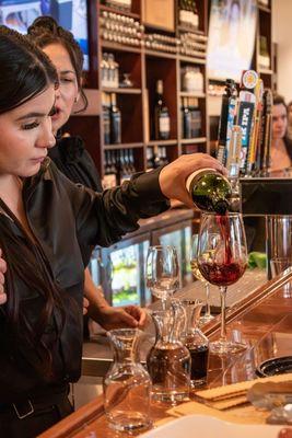 Pouring wine at our bar