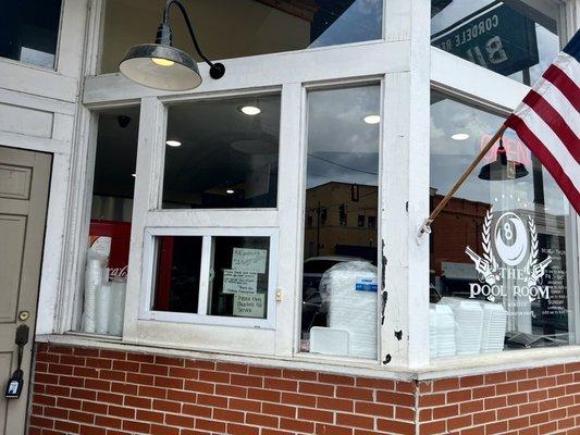 The window where women used to be served when it was a smoky old pool hall