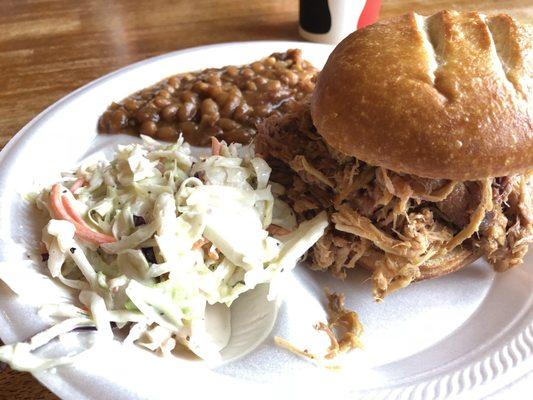 Pulled pork meal comes with a VERY GENEROUS portion of meat on great tasting bread along with tasty coke slaw and beans.