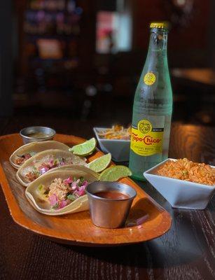 Carnitas, rice, and beans along with a mexican classic - topo chico