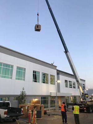 Installing new system using a crane is a safe way to get new units onto the roof