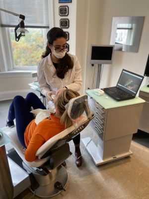 Dr. Annoni uses the digital scanner on a patient to create a digital model of her teeth and mouth.