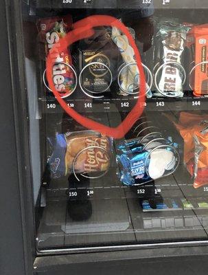 Condoms for sale on the lower tier of the public vending machine.