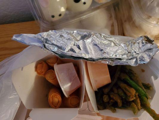 Chicken egg rolls, fried green beans and an orange chicken skewer.