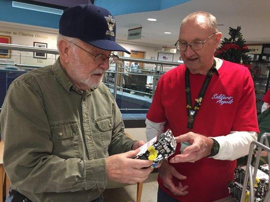 Soldiers' Angels volunteer handing out items to Veterans at VA Hospitals.