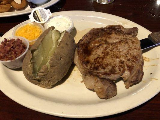 Ribeye with loaded baked potato