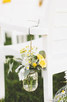 flowers hanging on the chairs along the aisle for my ceremony