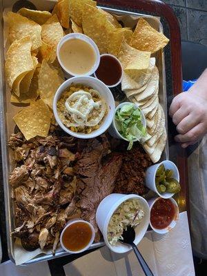 The Tex-Mex combo. Brisket, pulled pork, chorizo, cole slaw, Mexican street corn, flour tortillas, queso, salsa, and chips.