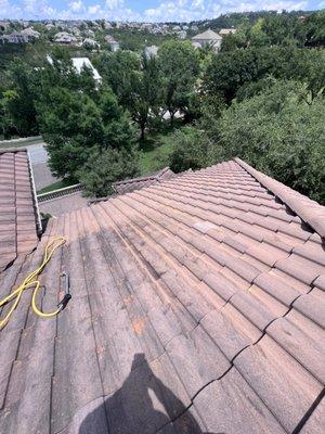 Clay barrel tile roof washing to remove moss, bacteria and lichen.