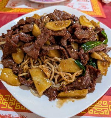 Ginger beef over fried noodles.