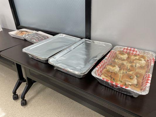 Chicken salad mini-wiches along with quarter sized Reuben sandwiches and club sandwiches; packaged brownies and cookies.