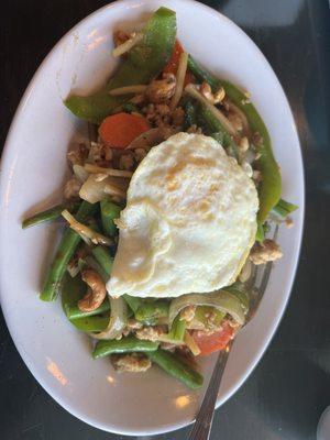 Basil Chicken with Green Beans, onions, bamboo shoots, green bell peppers and carrots.  Fried egg on top.