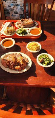 My husbands plate with chicken, sausage, and brisket with cream corn and green beans.  We also had a bowl of bbq sauce.