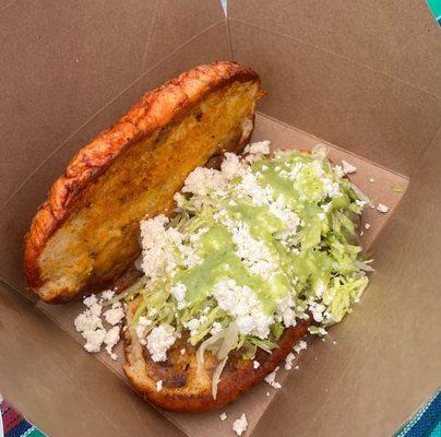 Potato with soy chorizo Pambazo topped with lettuce sour cream and queso fresco