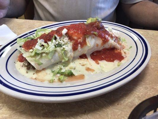 Ground beef burrito with cheese sauce and my husband tops it off with salsa