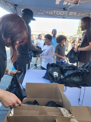 Our students are receiving goodie bags from LAFC!! Amazing event held to inaugurate the opening of our new Futsal field!!