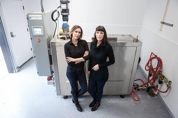 Owners and sisters Joslin Roth and Darci Bressler with the disposition equipment they employ to offer aquamation to their community.