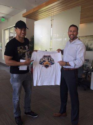 Our patient Giancarlo Stanton and Dr Craig Spodak approve the new logo for our charity, All Star Smiles.