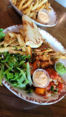 Chicken shawarma bowl with aioli and zoug sauce, plus side of zatar fries.