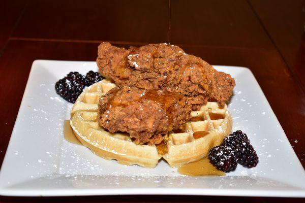 Chicken and waffle paired with syrup and butter