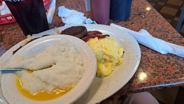 Sausage, bacon, hash browns, grits, and French toast