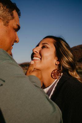 couples session during golden hour. couple looking lovingly into each others eyes.