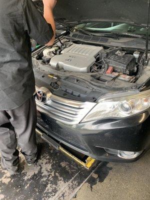 Manager overlooking obvious spots of oil on the trim and engine cover.