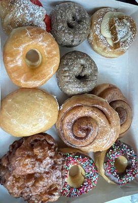 Strawberry croissant, blueberry, pumpkin spice, cinnamon rolls, cream filled, fritter and chocolate with sprinkles