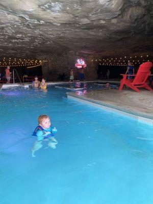 Pool in the cave with corn hole and dinning tables