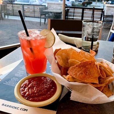 Strawberry margarita with fresh chips & salsa.