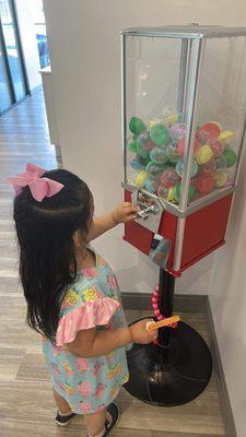 Gum ball machine with a toy