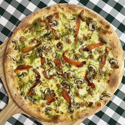 Rotating Pizza Lab: "Is It Spring Yet?"
 
 Arugula pesto base with aged mozz, roasted red pepper, sausage & mushroom.