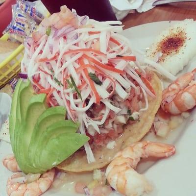 Tostada mixta. It has two tortillas,  crema, ceviche, shredded crab leg, avocado,  and shrimp.  $8.99. Huge portion. Delicious!