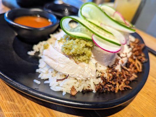 Hainan Chicken. $17. Poached chicken, cucumber salad, chili, and soy sauce. Singapore's national dish.