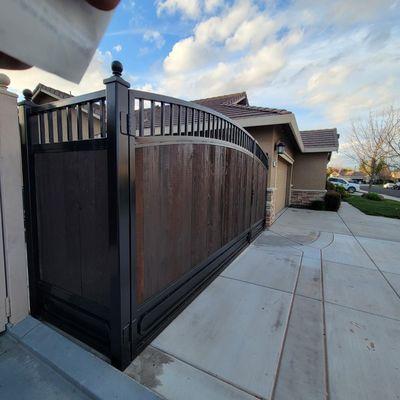 Custom iron gate with stained wood.